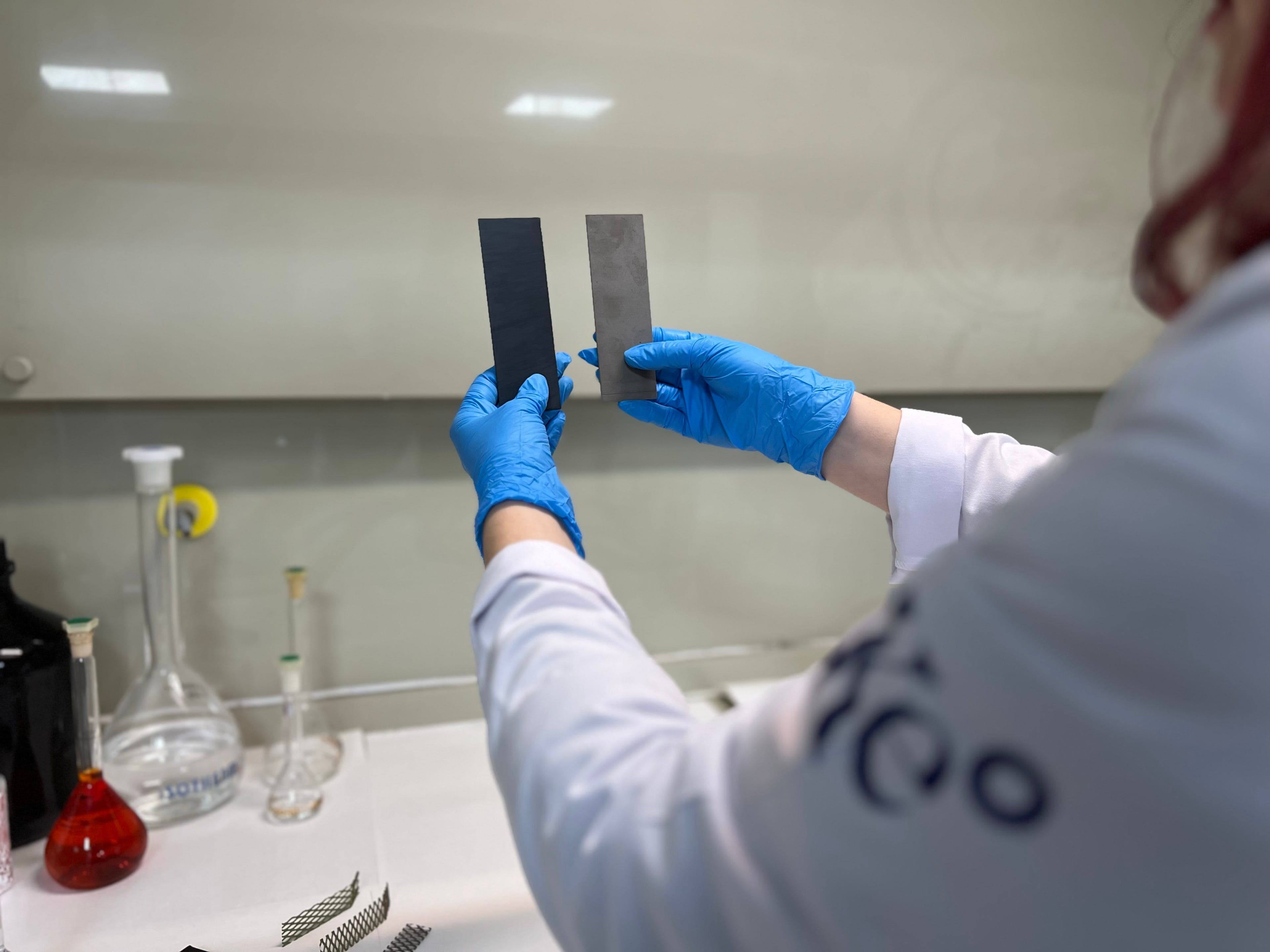 Kemisan technician in lab coat reviewing CX onsite NaOCl generation equipment