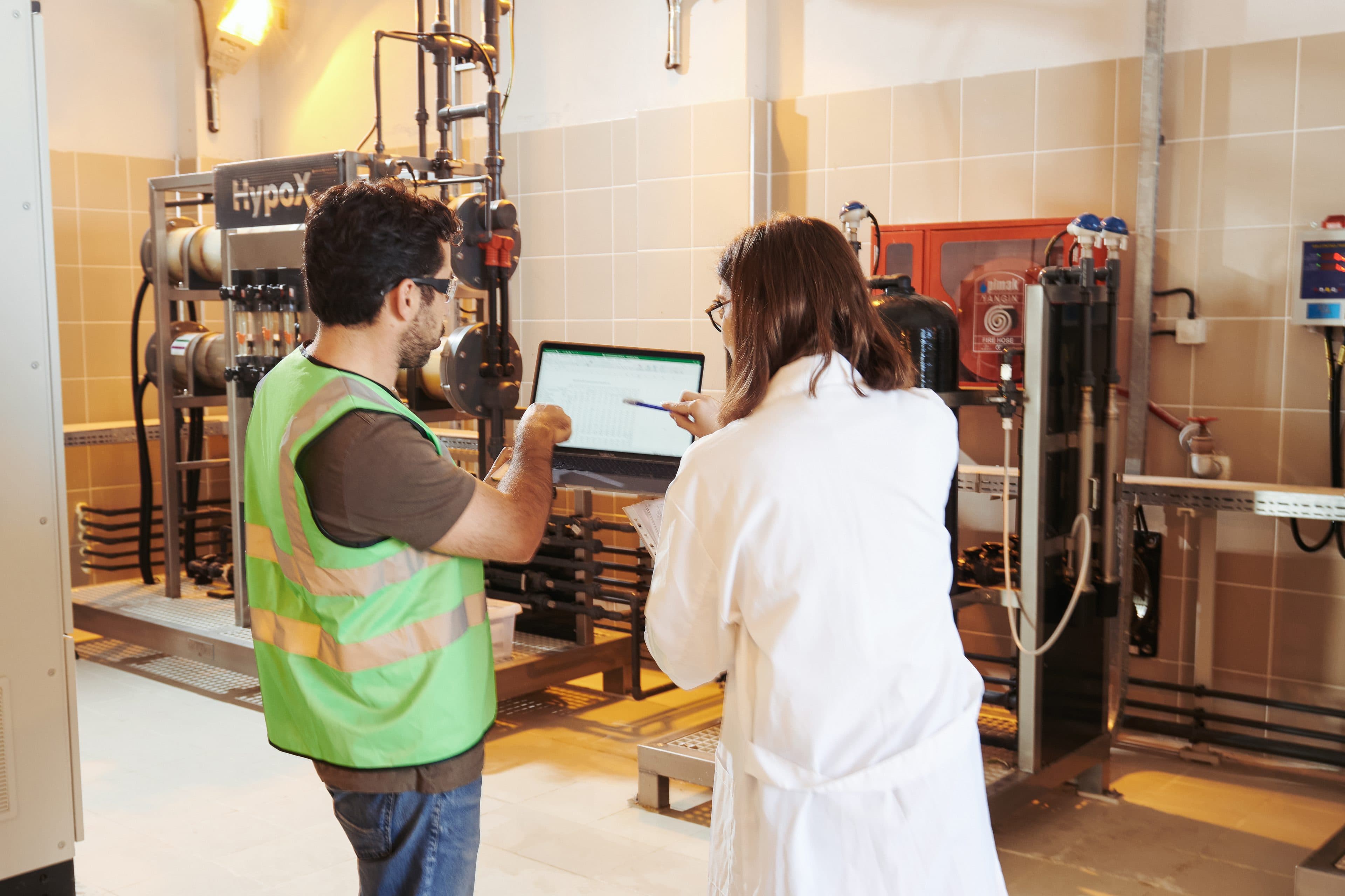 Engineers monitoring HypoX on-site chlorine generation system