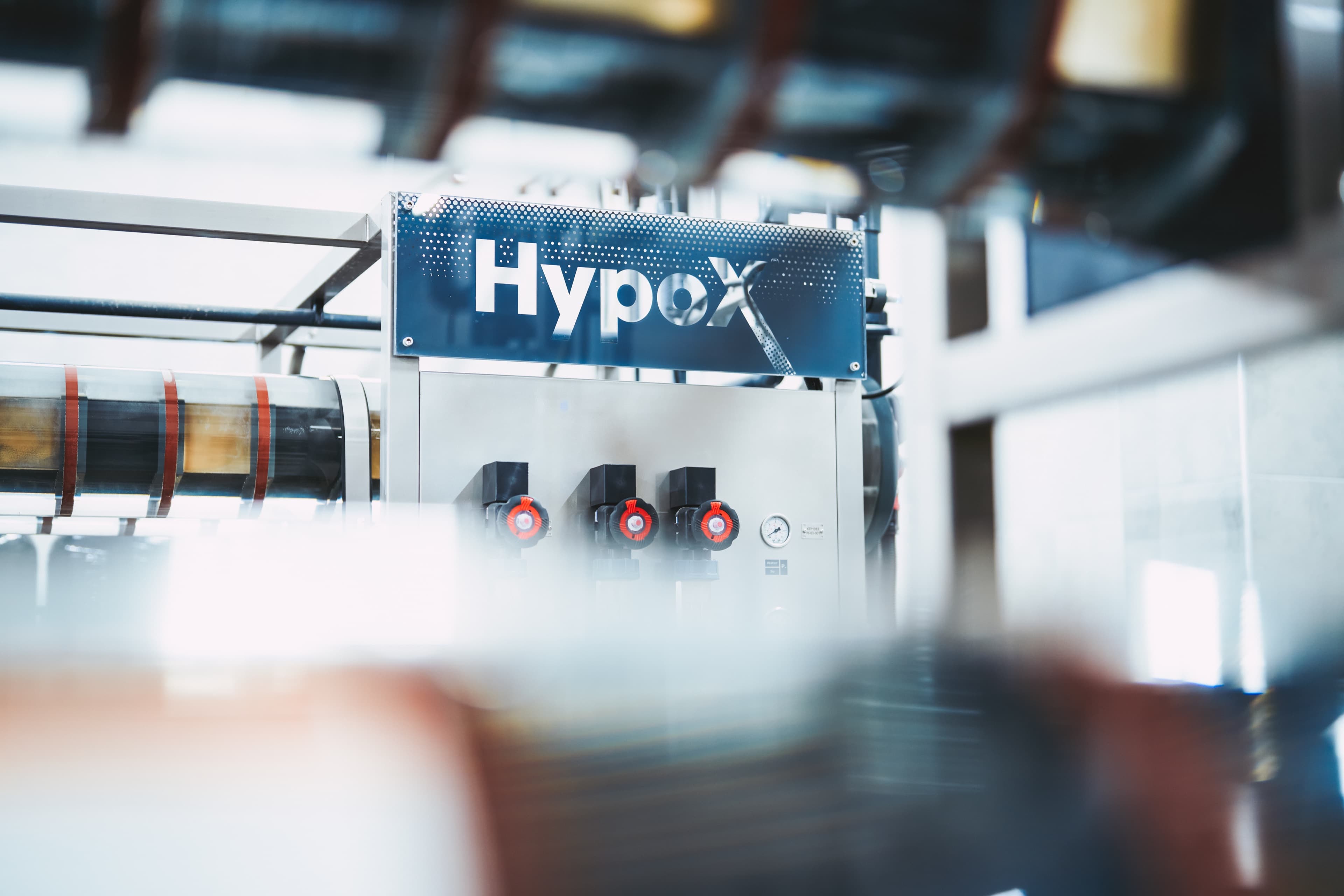 Close-up of a HypoX LX electrolyzer skid with branded panel, valves and instrumentation in a Kemisan production facility