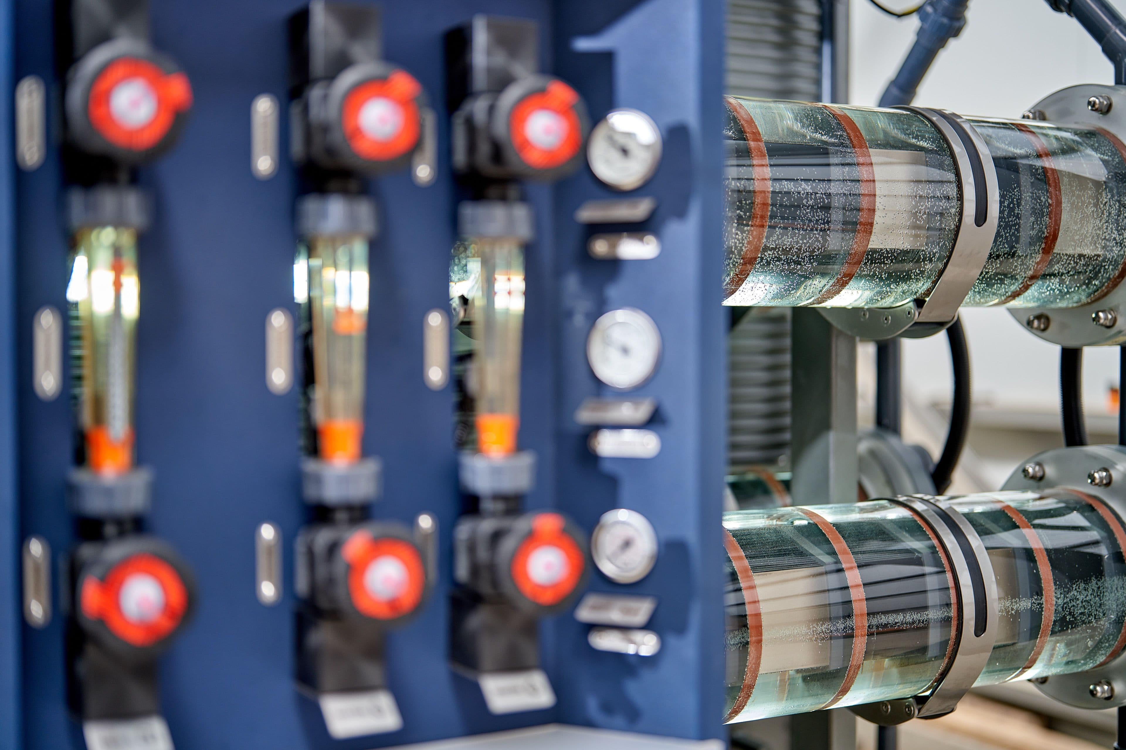 Close-up of a HypoX PX Series skid showing electrolyzer cells, pumps, and pressure gauges
