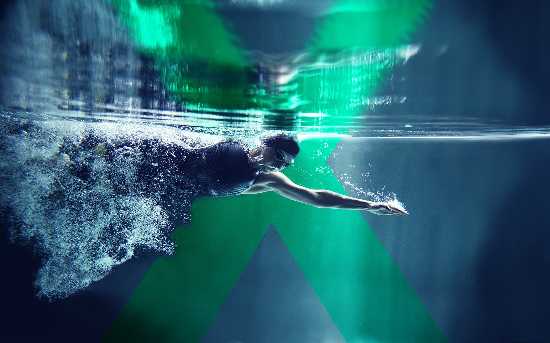 Swimmer gliding underwater in a swimming pool