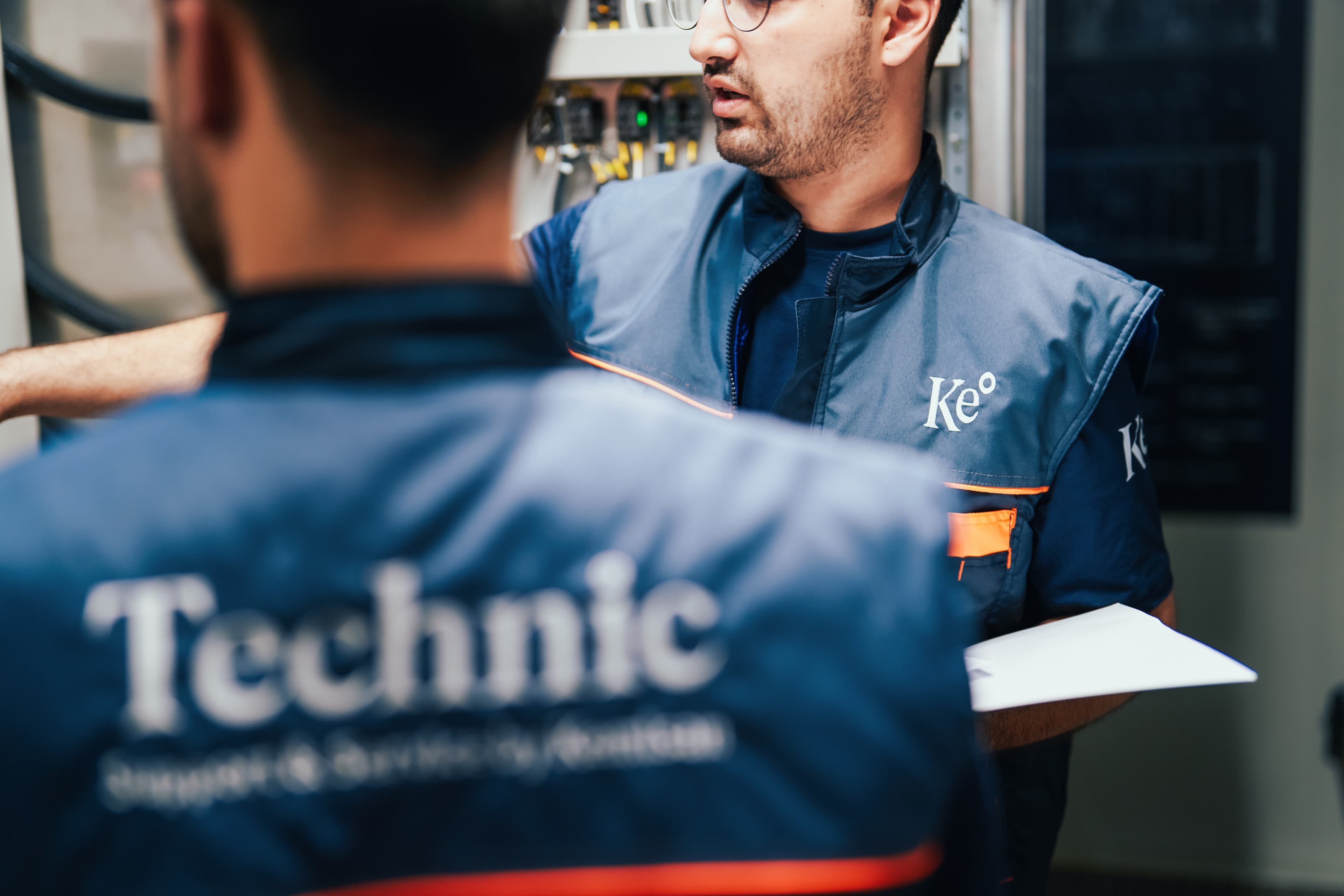 Two Kemisan technicians inspecting a HypoX TX electrochlorination unit from inside