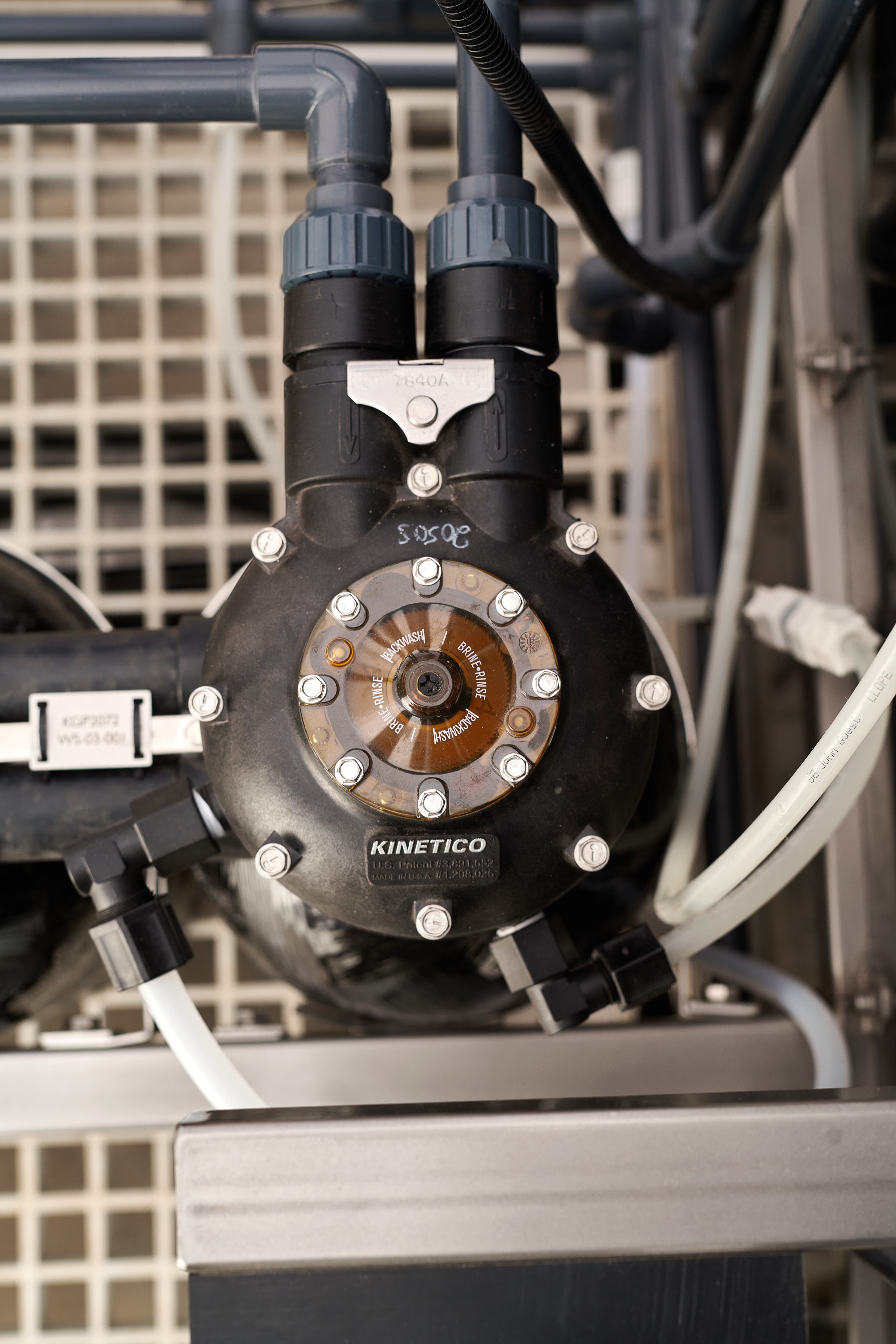 Twin resin tubes and a mechanical softener controller head on a HypoX TX skid, enabling continuous softening without electrical components